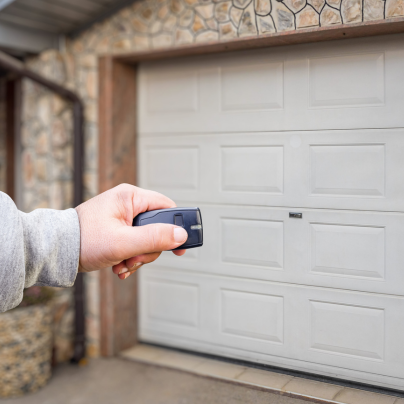 Binghamton security key fob pointing to a garage door